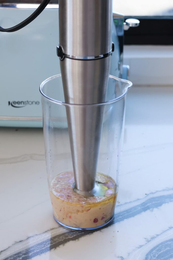 immersion blender blending a homemade shallot and red wine vinegar dressing