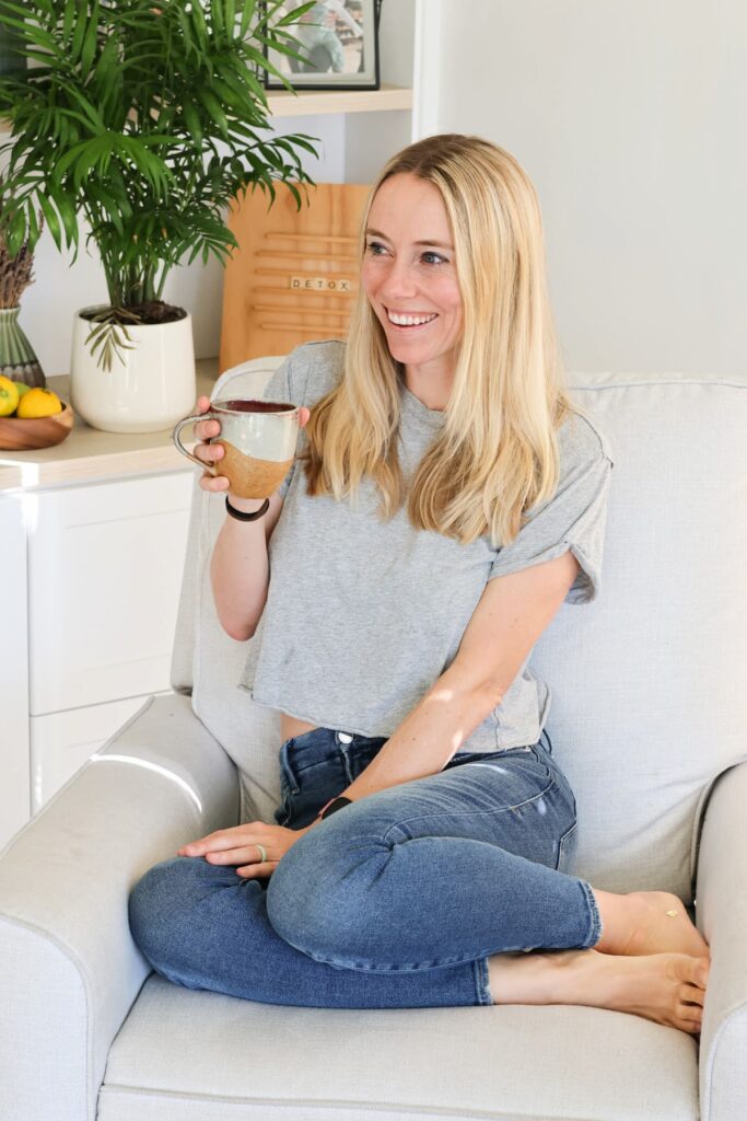 autumn bates sitting on a couch with a coffee mug