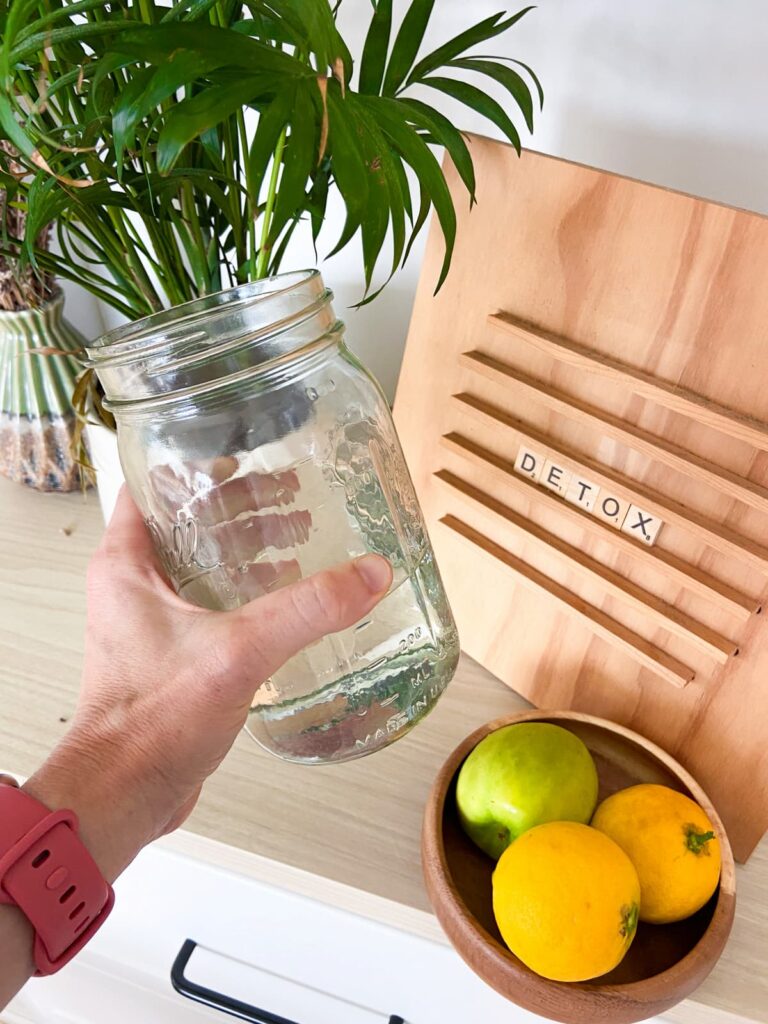 water mug in front of a sign that says detox