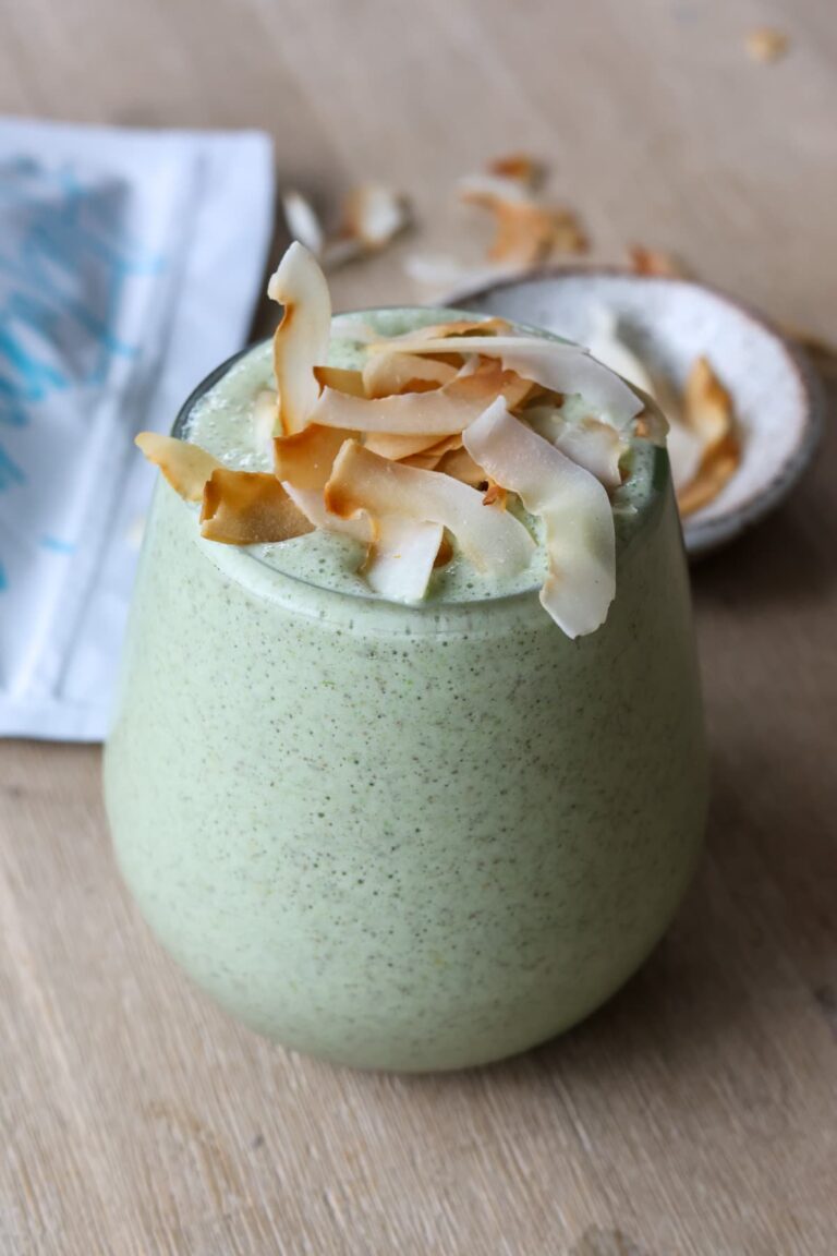 green protein smoothie with toasted coconut flakes topping