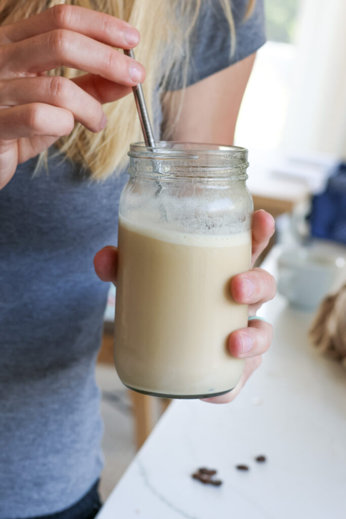 drinking an iced protein coffee