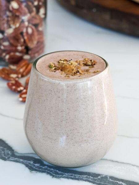 chocolate protein shake in a glass with toppings