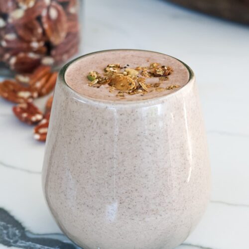 chocolate protein shake in a glass with toppings